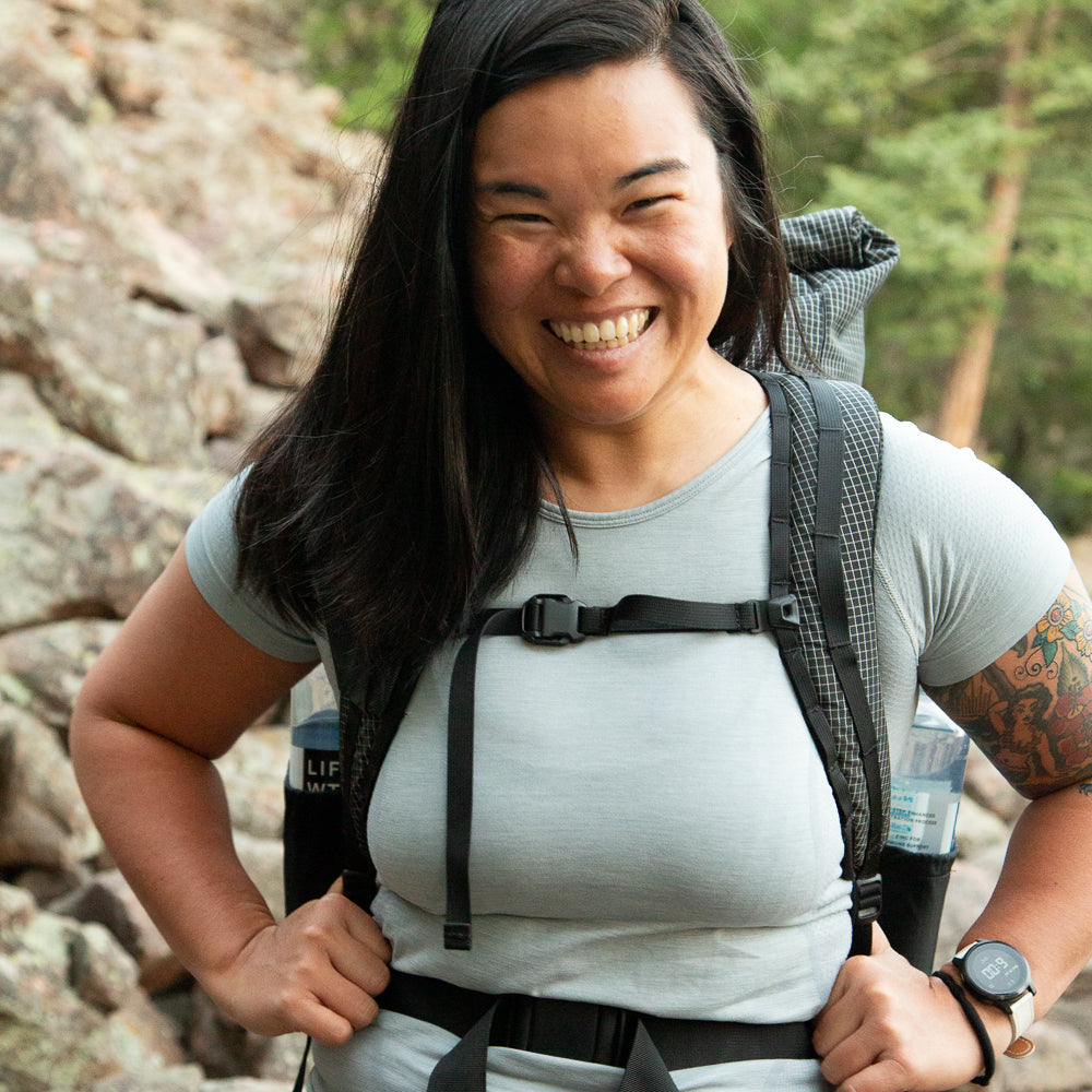 woman smiling wearing aspen backpack