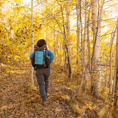 woman wearing backpack on trail